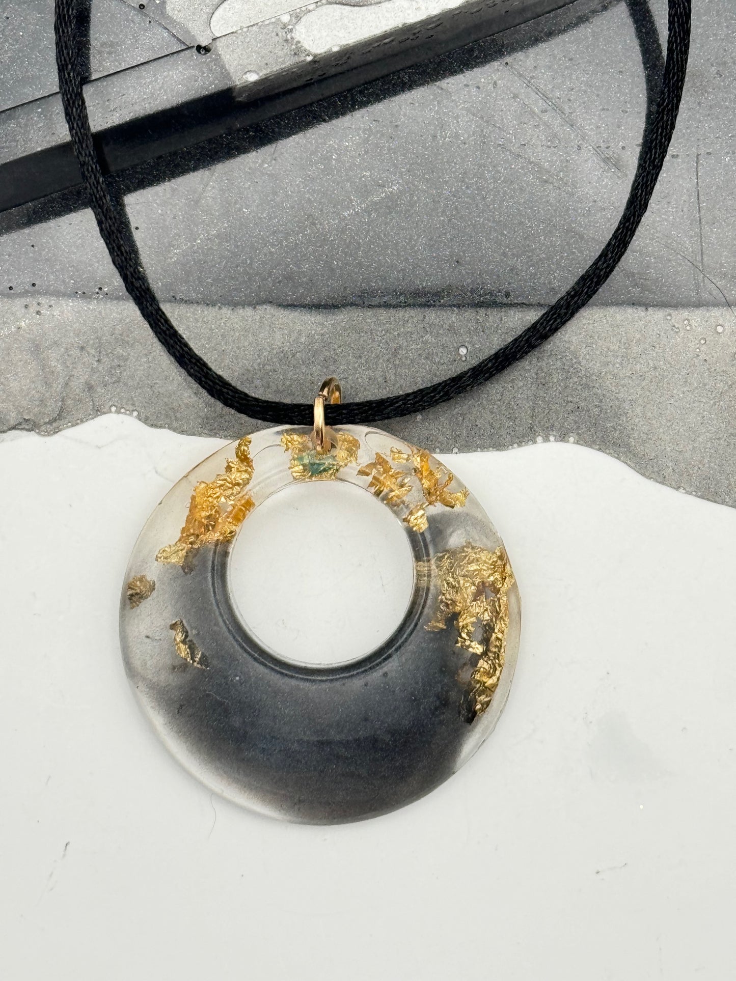Black and gold pendant with gold flakes
