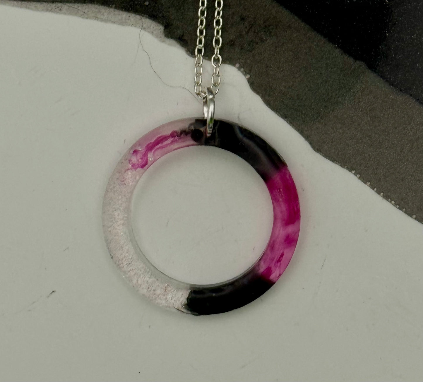 Pink and black circle pendant with glitter