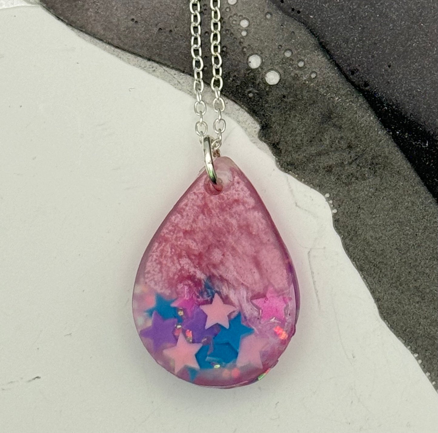 Pink teardrop pendant with stars