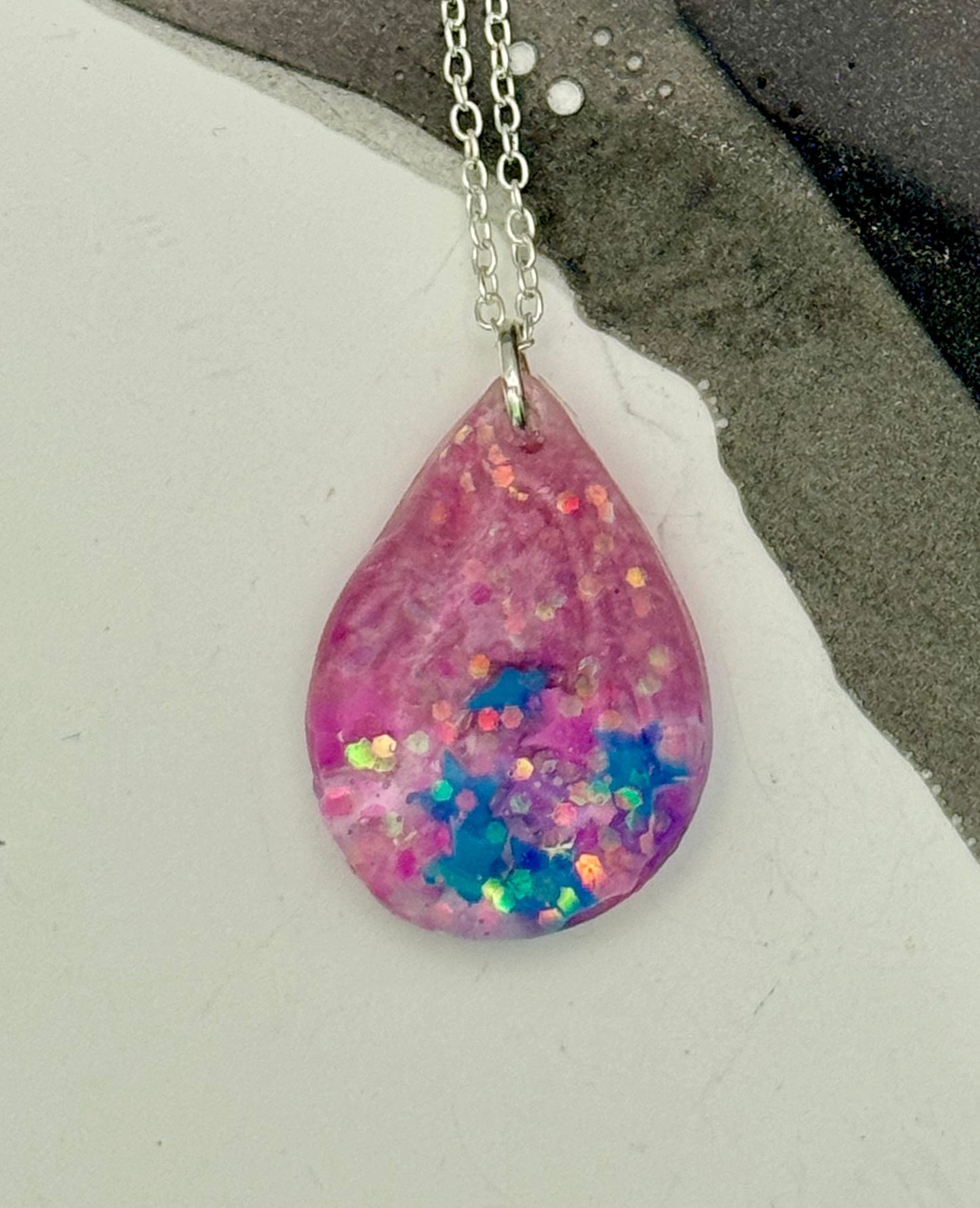 Pink teardrop pendant with stars