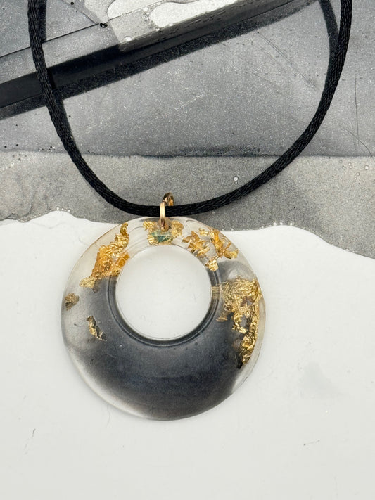 Black and gold pendant with gold flakes