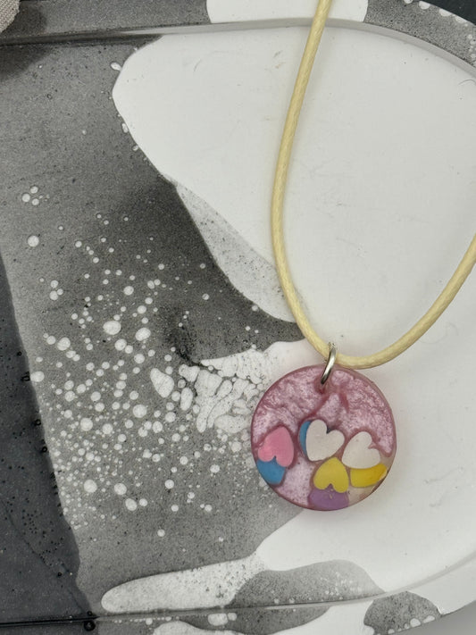 Pink circle pendant with hearts