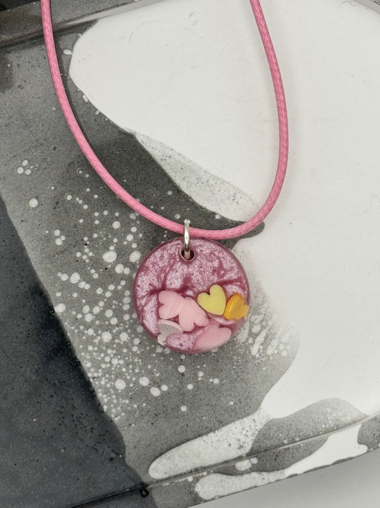 Pink circle pendant with hearts