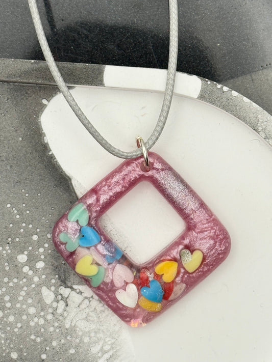 Pink pendant with multicolored hearts