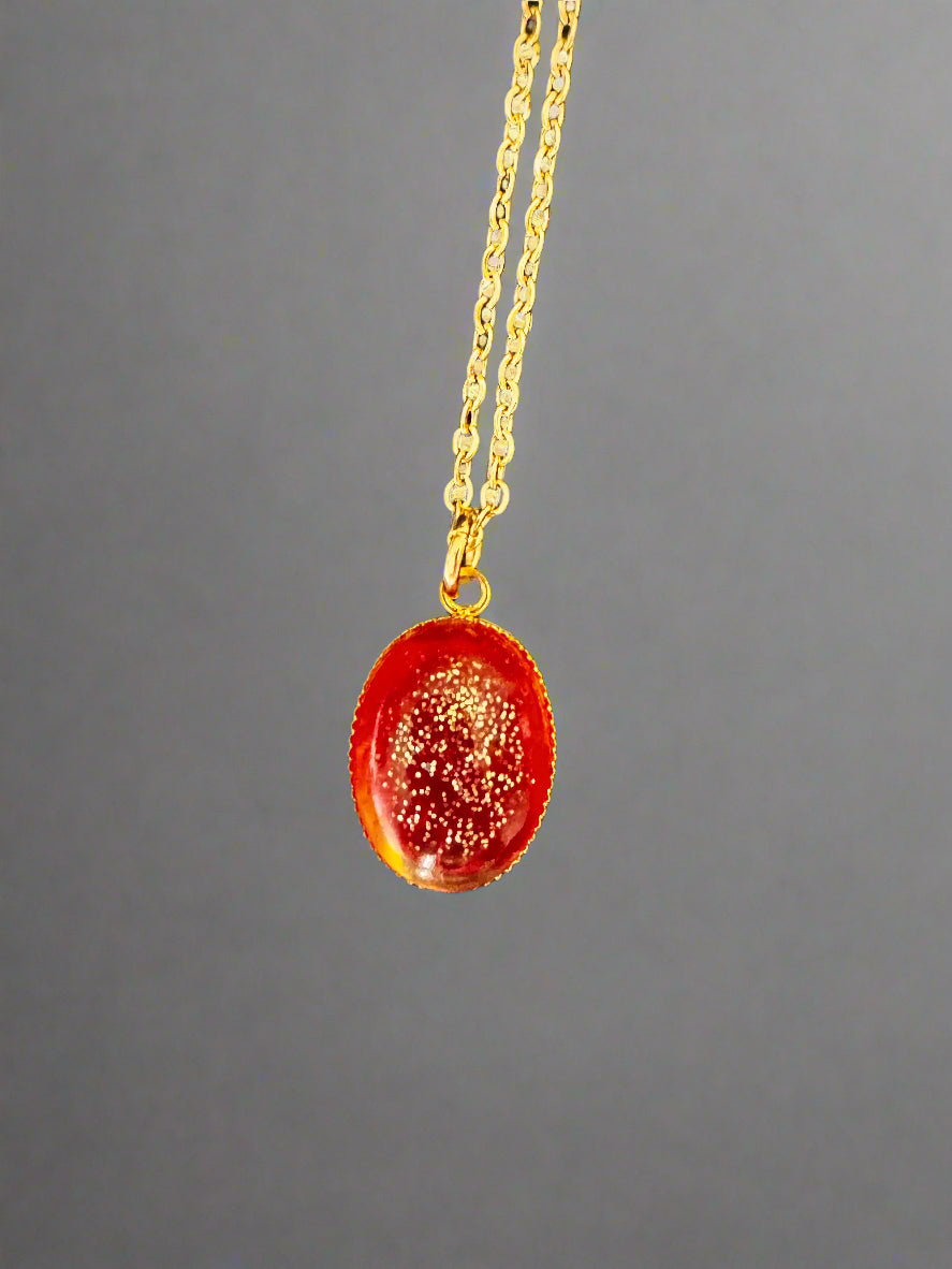 Necklace with a red pendant on a black background